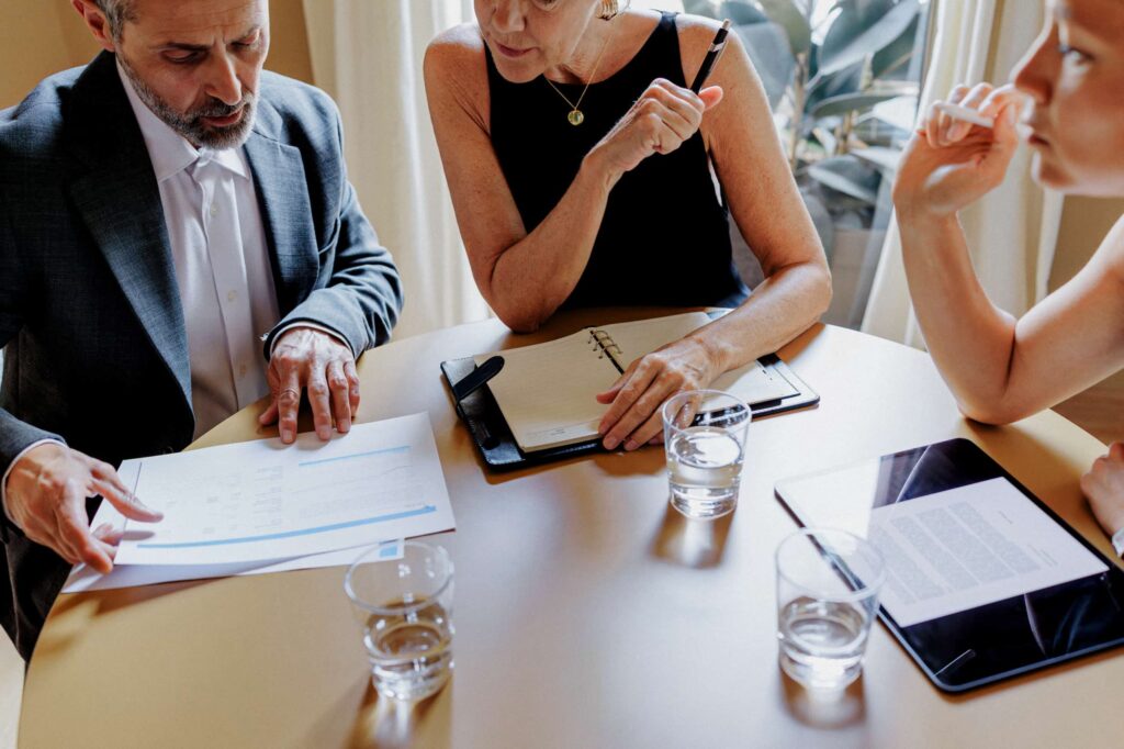 Three people in a meeting at a table