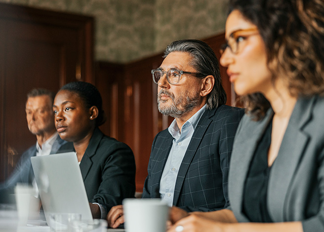 Male and female business professionals attending meeting at office