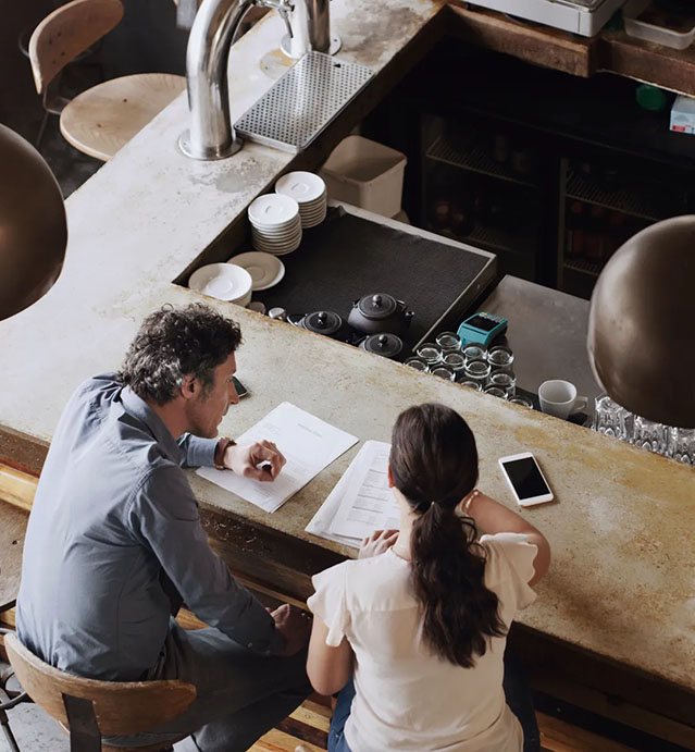 Cropped shot of two businesspeople doing business in a coffee shop